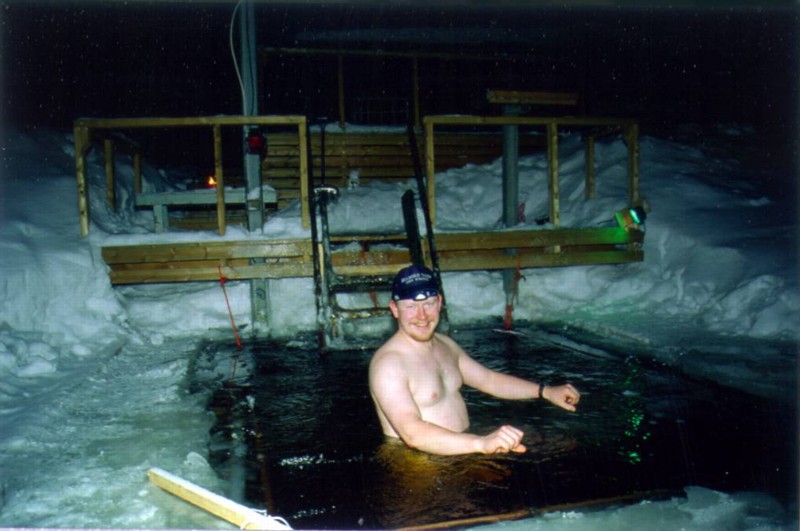 A winter motorcyclist melts in the lake Immeljrvi. Feet are already OK but shoulders and hands still suffer from the long day in the saddle.