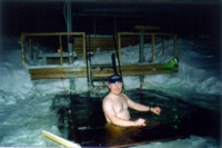 A winter motorcyclist melts in the lake Immeljrvi. Feet are already OK but shoulders and hands still suffer from the long day in the saddle.